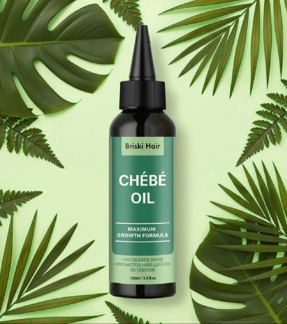Briski Hair Chébé Oil bottle on a green background with leaves